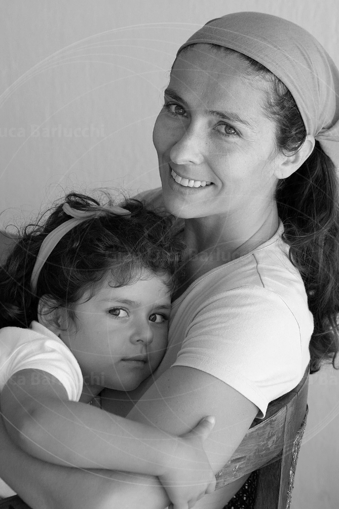 Black-and-white photograph of a woman holding a curly-haired child