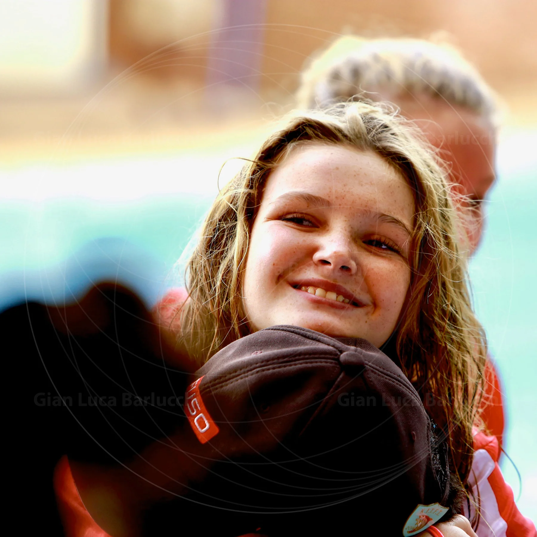 Smiling young swimmer beside a pool