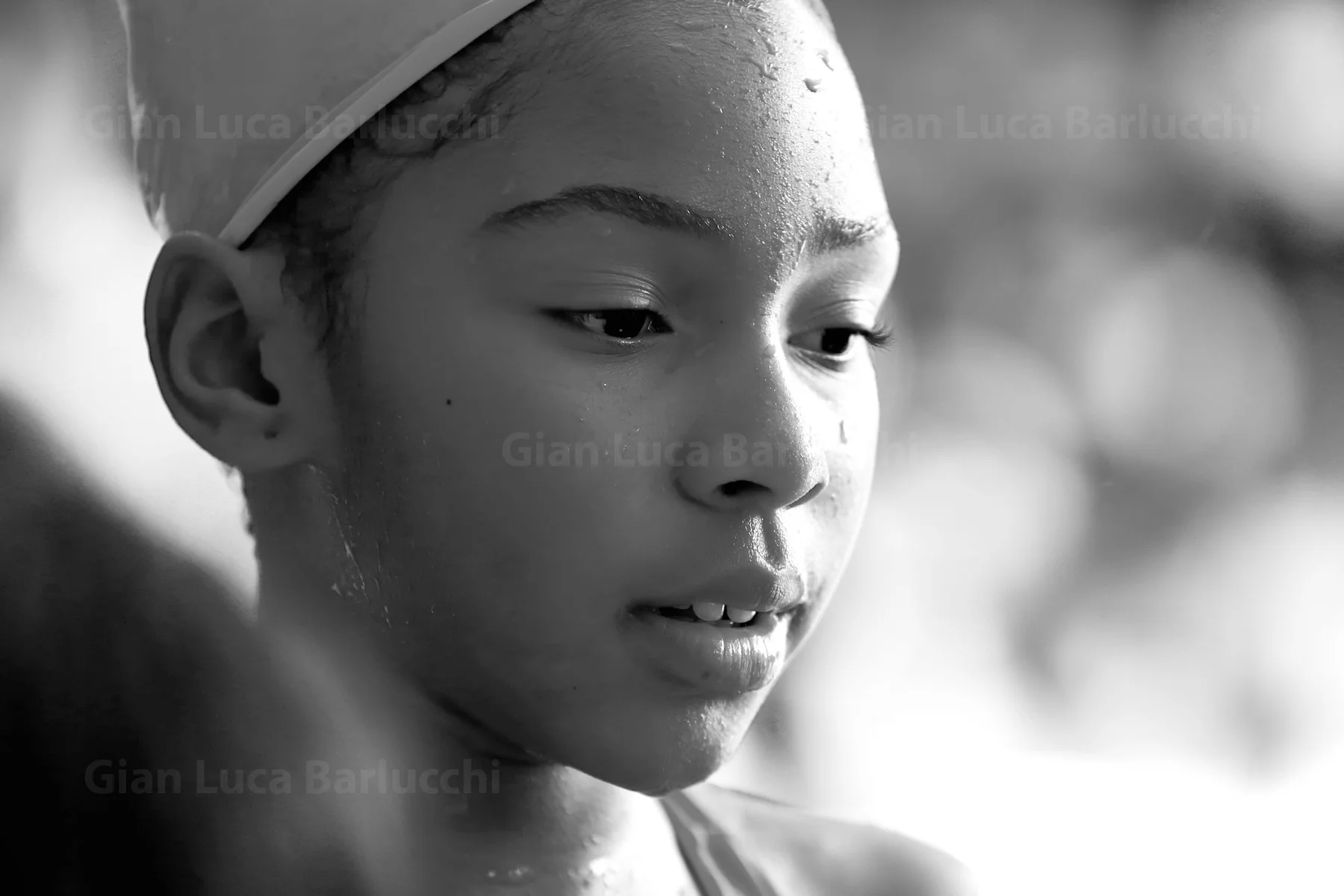 Black-and-white portrait of a child wearing a cap