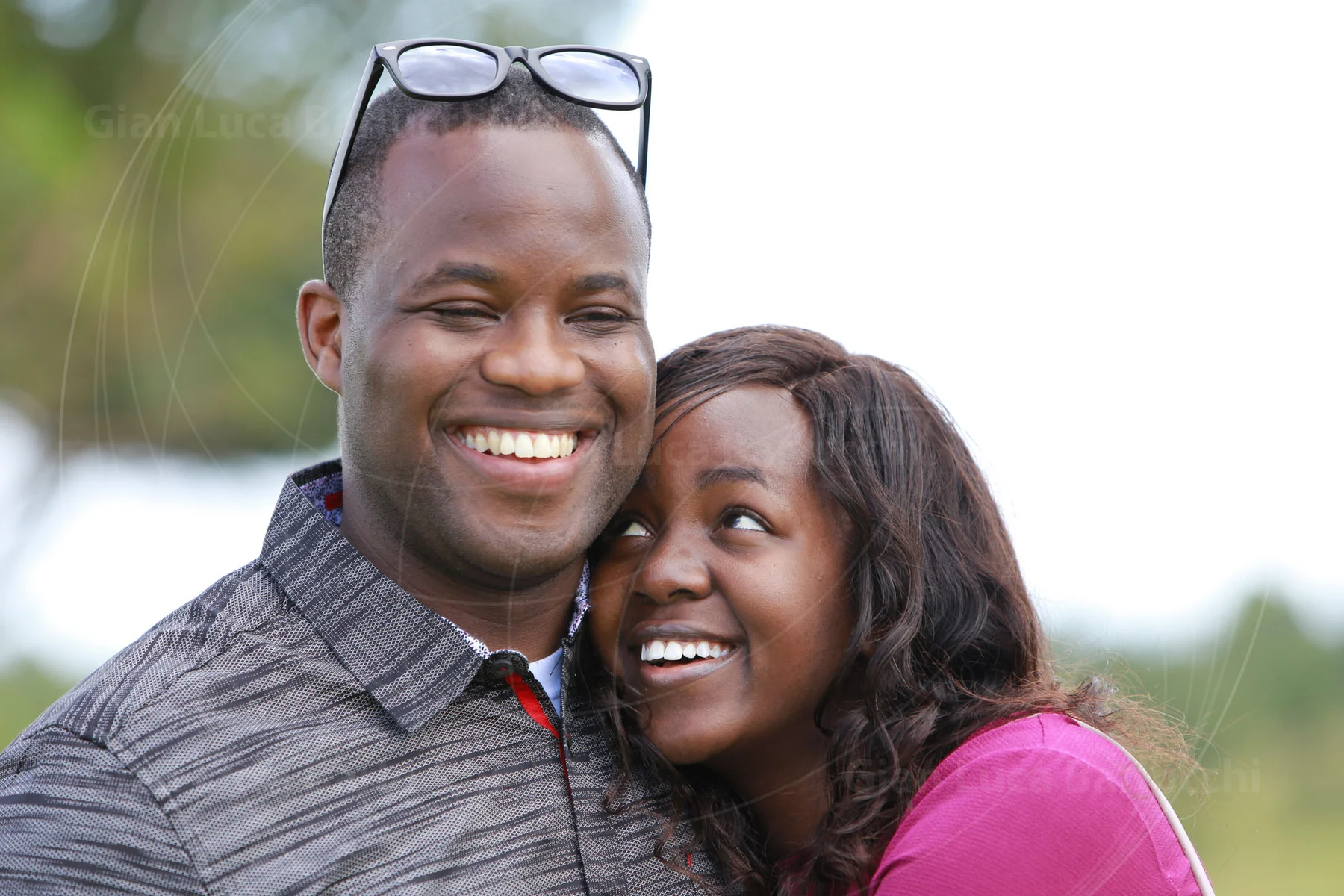 Smiling couple standing close together outdoors