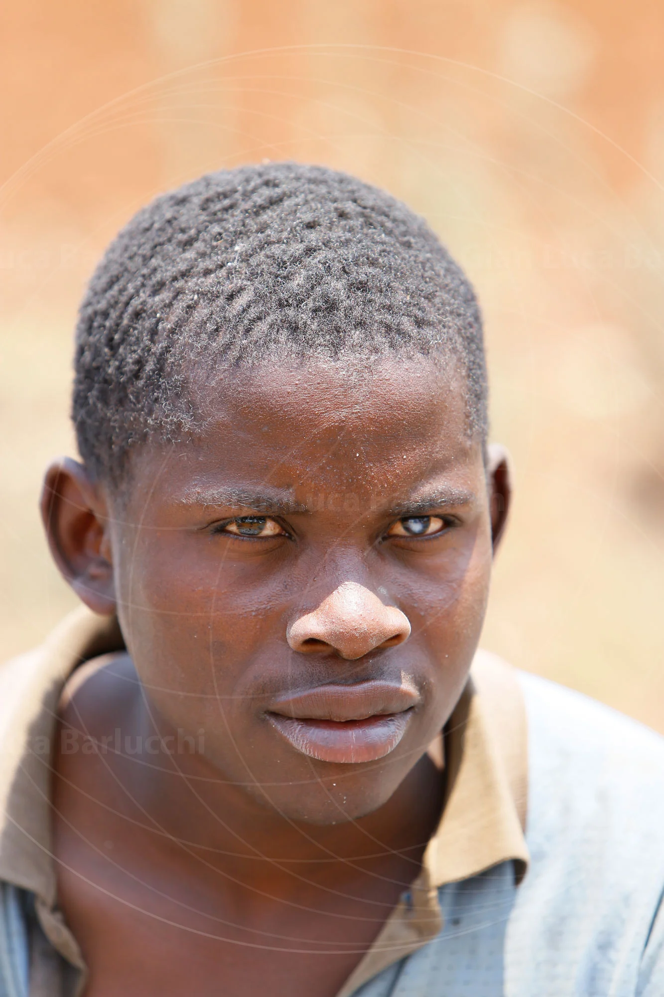 Portrait of a man looking toward the camera in bright sunlight